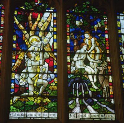 Stained glass windows depicting The Annunciation and Adam and Eve in the Garden of Eden by English School